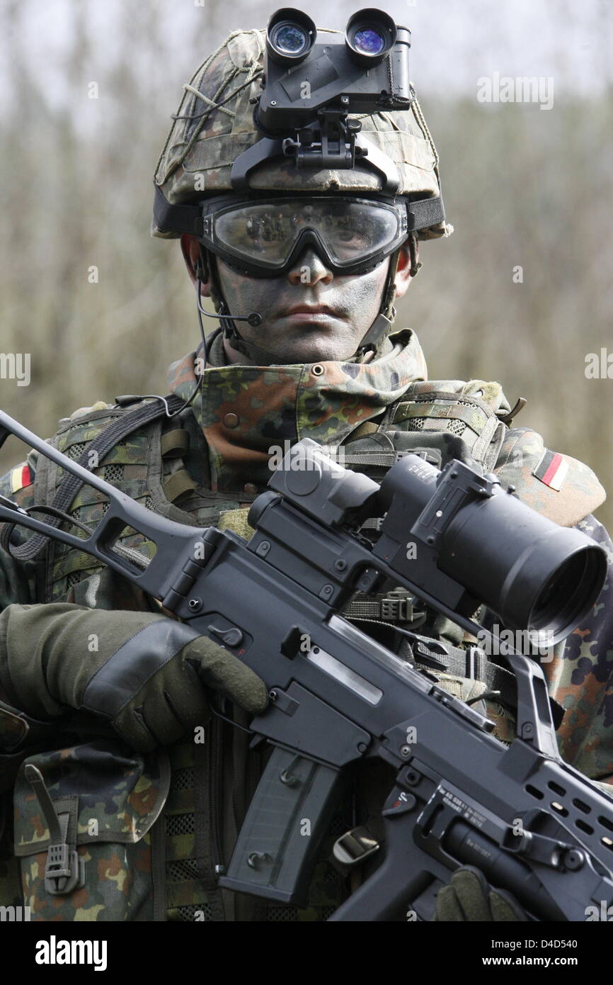 A soldier of the 21rst infantry brigade, which will form part of the Quick Reaction Force (QRF) in Northern Afghanistan, is pictured with 'Infantryman of the Future' equipment at a training area in Bergen, Germany, 17 March 2008. The first pre-dated commandos of the German QRF are scheduled to be dispatched to northern Afghanistan beginning of July. Infantrymen of the 21rst brigade Stock Photo