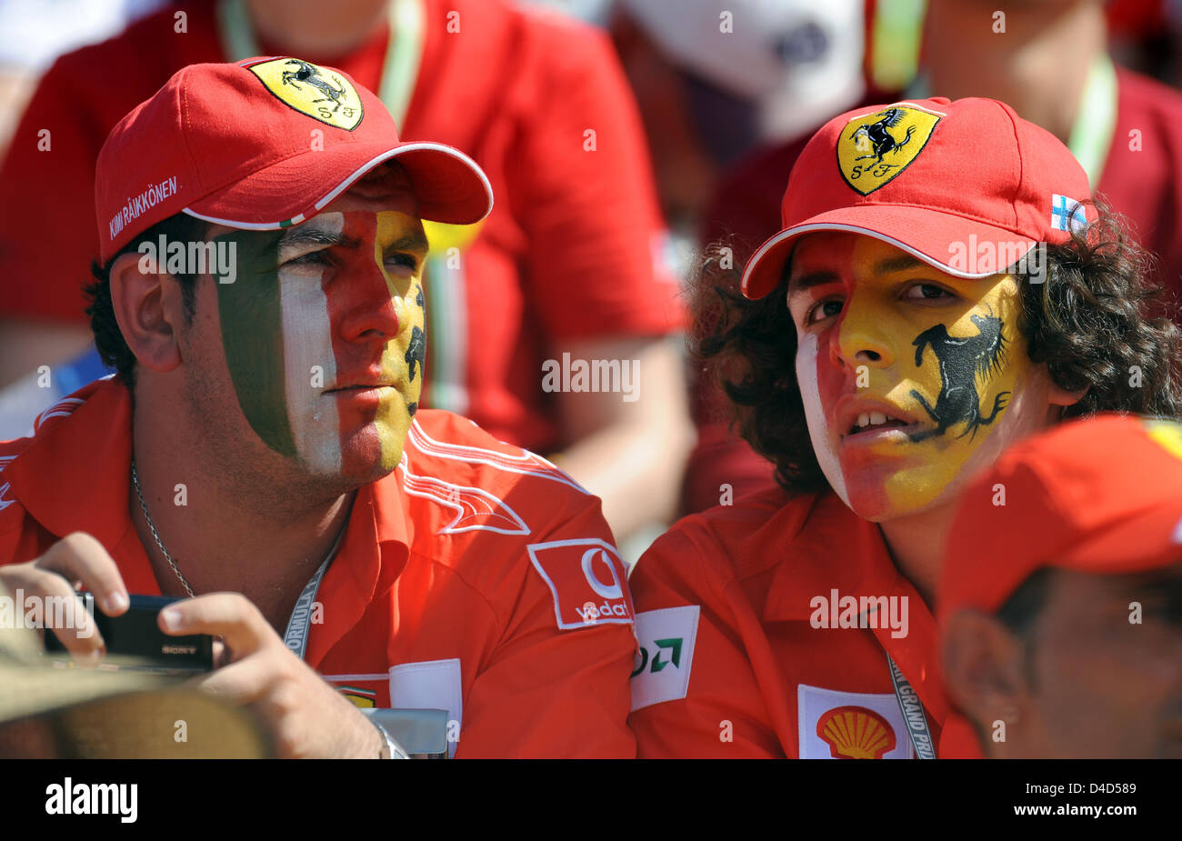 A group of Ferrari fans watches the Formula 1 Australian Grabnd Prix at Albert Park circuit in Melbourne, Australia, 16 March 2008. British Lewis Hamilton of McLaren-Mercedes homed a pole-to-flag victory in an action-packed and crash-strewn Australian GP. Photo: Gero Breloer Stock Photo