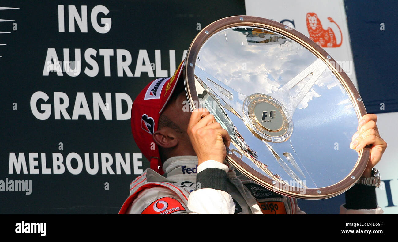 British Formula One driver Lewis Hamilton of McLaren-Mercedes kisses the trophy for winning the Formula 1 Australian Grand Prix at Albert Park circuit in Melbourne, Australia, 16 March 2008. Hamilton homed a pole-to-flag victory in an action-packed and crash-strewn Australian GP. Photo: Roland Weihrauch Stock Photo