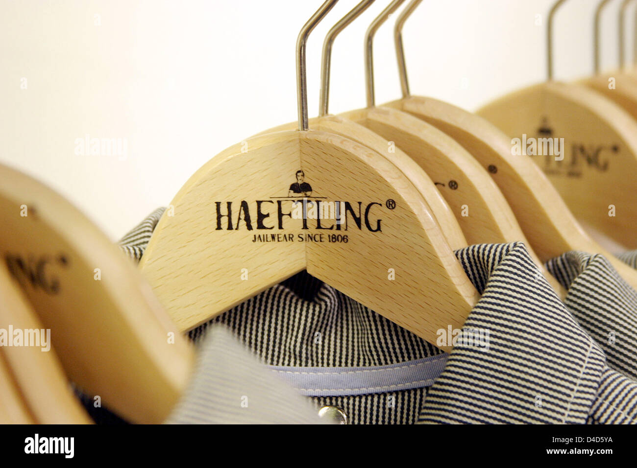 Shirts by 'Haeftling' ('Prisoner') on a hanger are for sale at the new 'Haeftling Jailwear' store in Berlin, Germany, 21 February 2008. At the shop, Stefan Bohle, brand advertiser for 'Haeftling Jailwear', sells clothing made by prisoners of the Tegel correction facility. The prisoners' collection is rugged, robust and rather colourless. Photo: Xamax Stock Photo