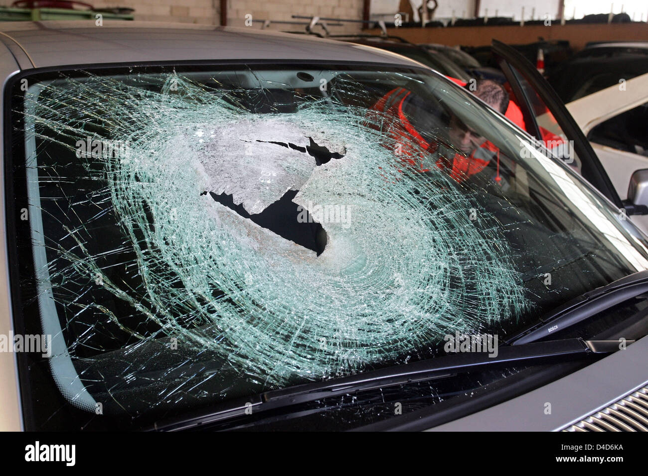 The picture shows the broken windscreen of a car after it was hit by