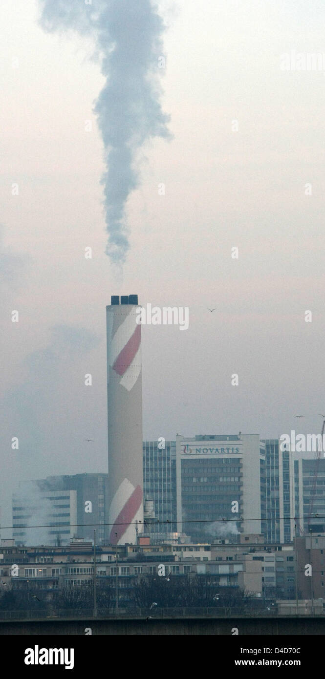 The picture shows a smoking chimney and the plant of pharmaceutical company Novartis in the early morning in Basel, Switzerland, 11 February 2008. Photo: Patrick Seeger Stock Photo
