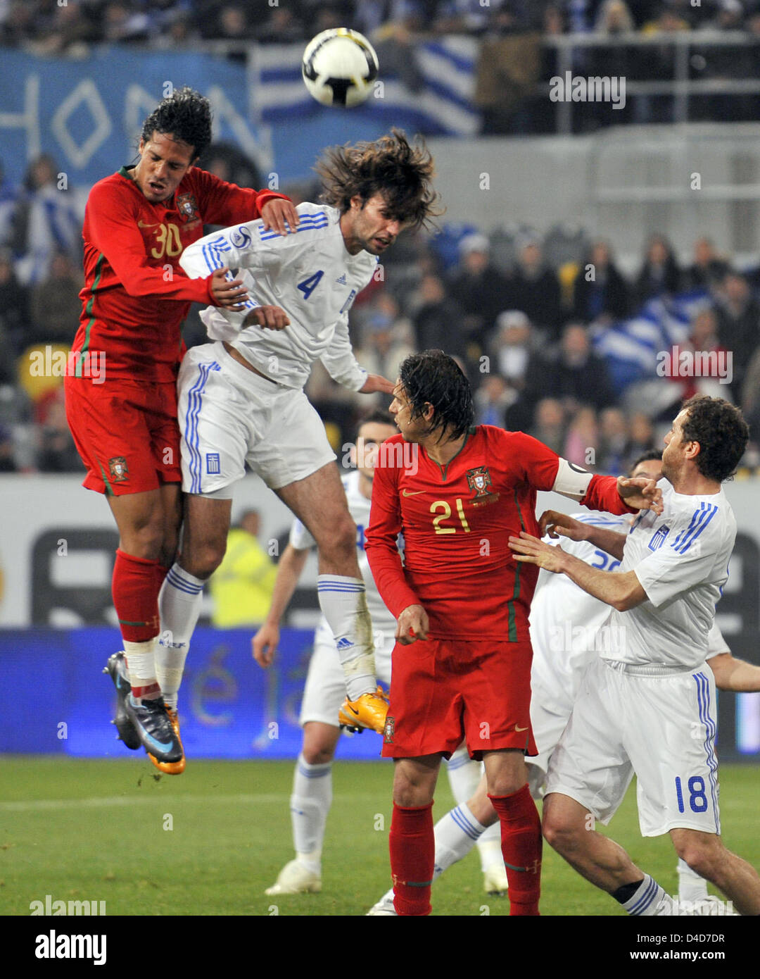 Portugal's Bruno Alves (L) and Greece's Georgios Samaras (2-L) rise for a heading duel in the test cap Portugal v Greece at LTU Arena stadium in Duesseldorf, Germany, 26 March 2008. Greece defeated Portugal 2-1. Photo: Achim Scheidemann Stock Photo