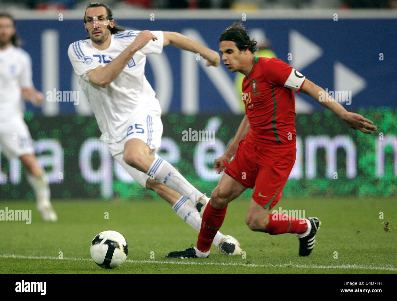 Greece's full-back Sotirios Kyrgiakos (L) watches Portugal's Nuno Gomes score the 1-2 in  the test cap Portugal v Greece at LTU Arena stadium in Duesseldorf, Germany, 26 March 2008. Greece defeated Portugal 2-1. Photo: Federico Gambarini Stock Photo