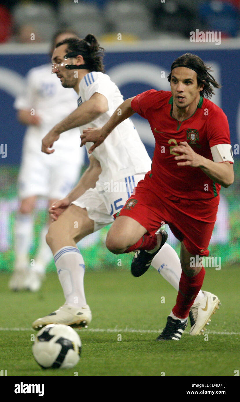 Greece's full-back Sotirios Kyrgiakos (L) watches Portugal's Nuno Gomes score the 1-2 in  the test cap Portugal v Greece at LTU Arena stadium in Duesseldorf, Germany, 26 March 2008. Greece defeated Portugal 2-1. Photo: Federico Gambarini Stock Photo