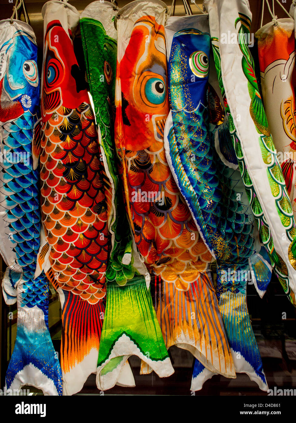 Colorful  koinoborri, carp streamers, flown to celebrate a traditional Japanese children's festival hanging outside a shop. Stock Photo