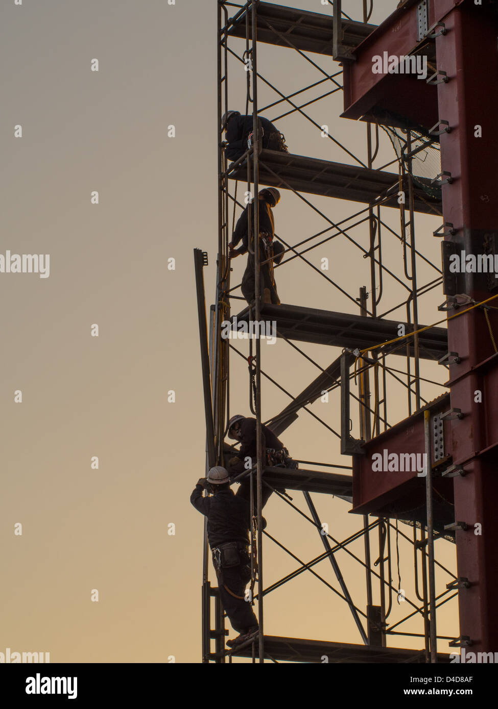 Japanese construction workers assembling scaffolding on a steel frame building in Kawagoe, Saitama, Japan. Stock Photo