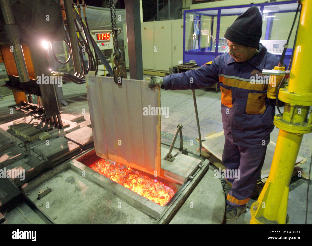 An employee of 'Deutsche Kabel AG Taschkent' ('German Cables SE Tashklent')  melts a copper plate with a 1,100 degrees Celsius-hot melting furnace at  the company's plant in Tashkent, Uzbekistan, 26 February 2008.