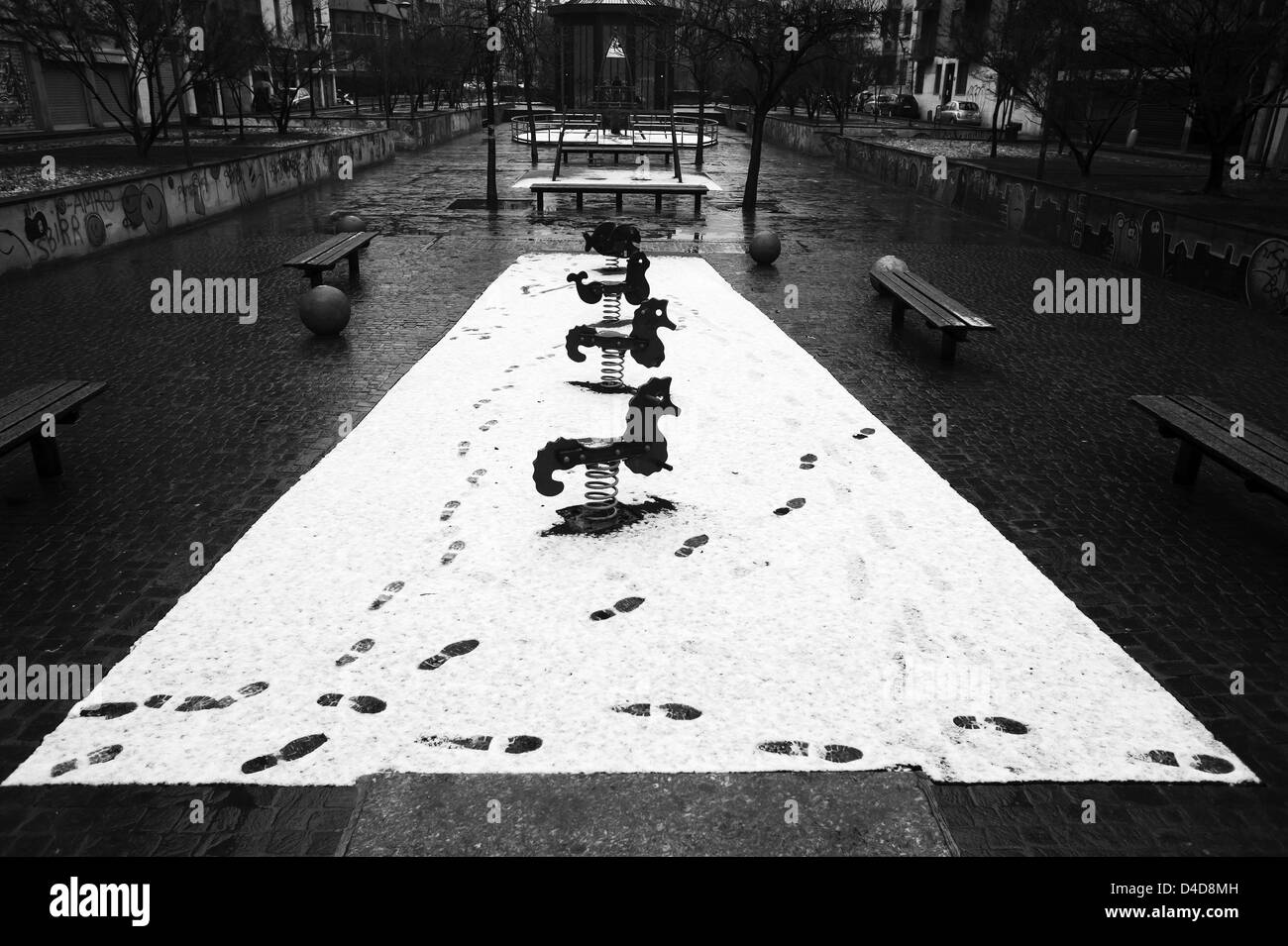 Footprints on kids playground under the snow Stock Photo