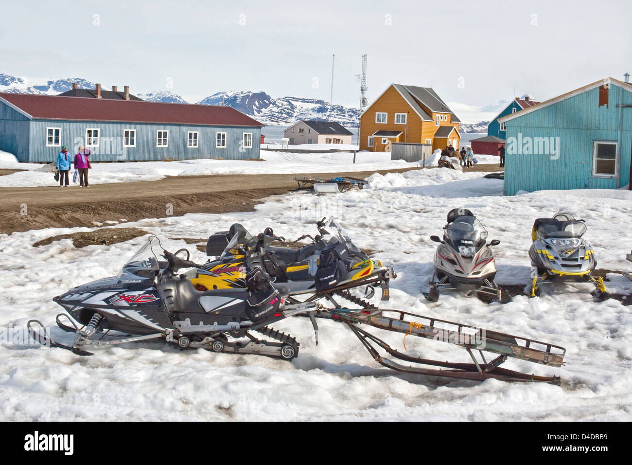 Snowmobiles with a sled trailer parked at the research station of Ny Alesund on Spitzbergen in the high Arctic. Stock Photo