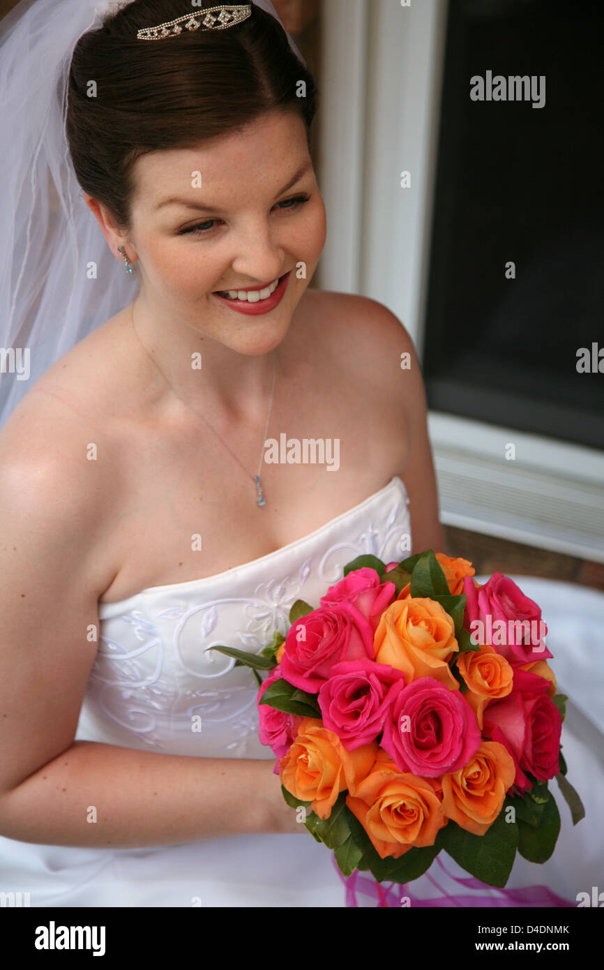 A Beautiful Bride with her Bouquet is smiling Stock Photo - Alamy