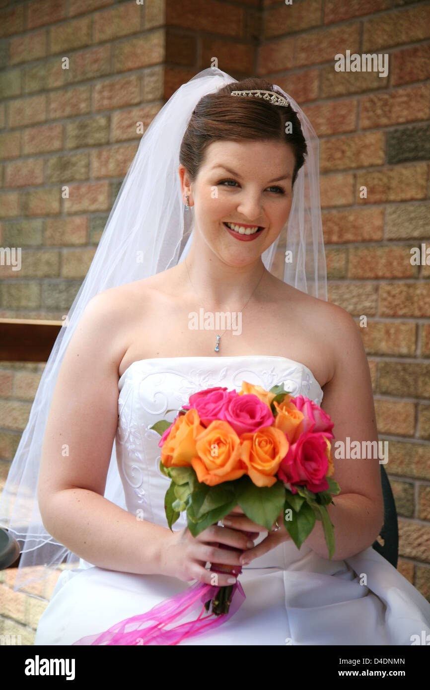 A Beautiful Bride with her Bouquet is smiling Stock Photo - Alamy