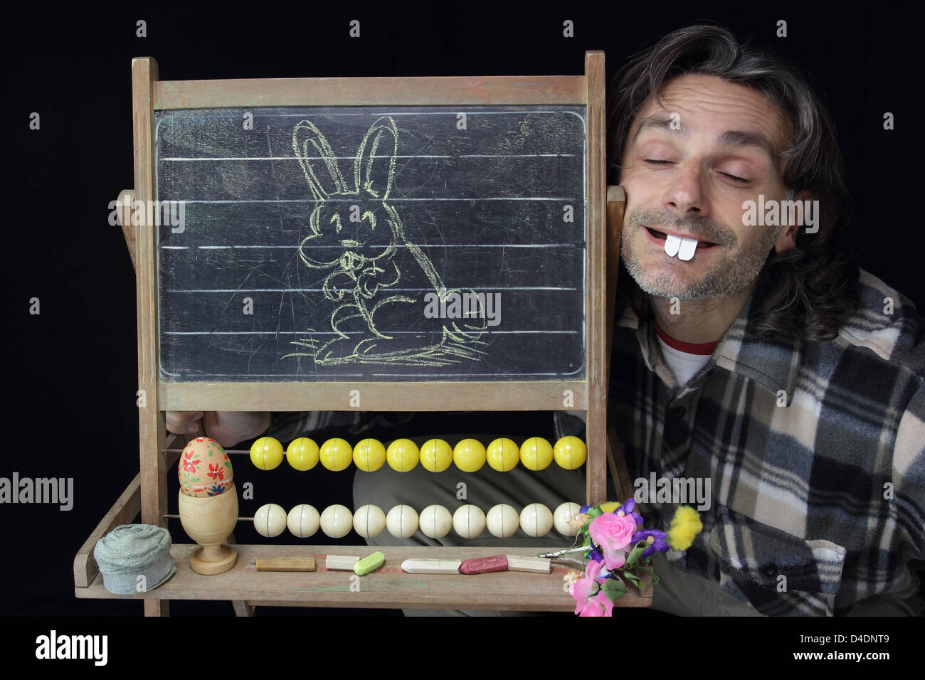 Funny Man Riding A Rabbit funny man showing a rabbit sketch on blackboard Stock Photo - Alamy
