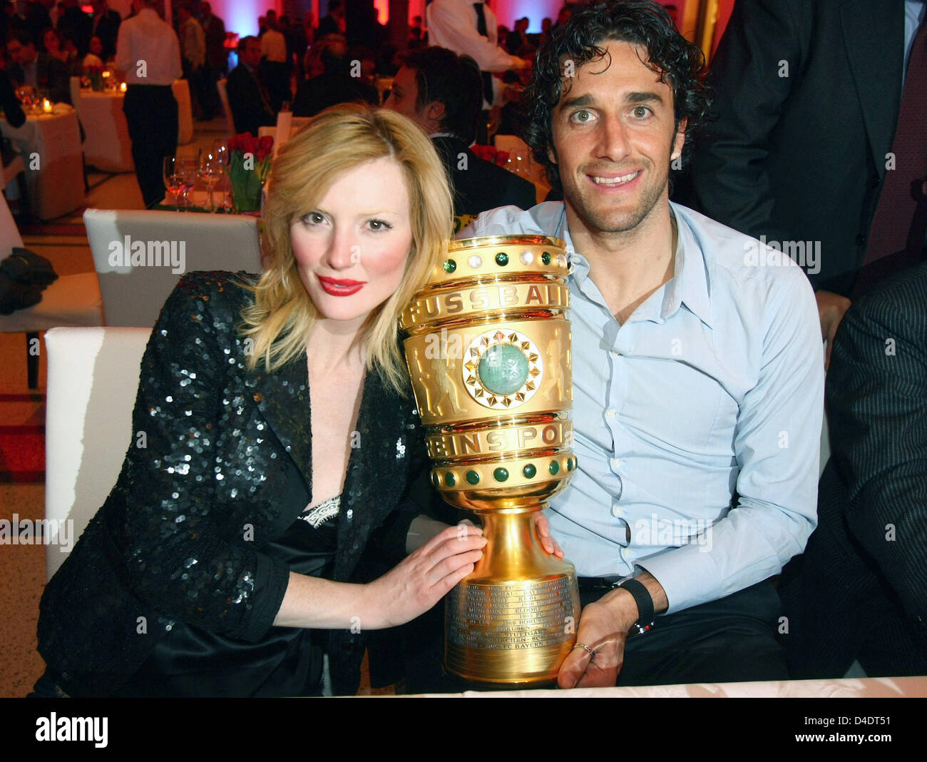 Luca Toni of Bayern Munic poses with his girlfriend Marta Cecchetto and the DFB-Trophy during the Bayern Munich champions party after the DFB Cup Final match between Borussia Dortmund and FC Bayern Munich at the Deutsche Telekom Represantive House Berlin, Germany, in the early morning of 20 April 2008. Photo: Alexander Hassenstein Stock Photo