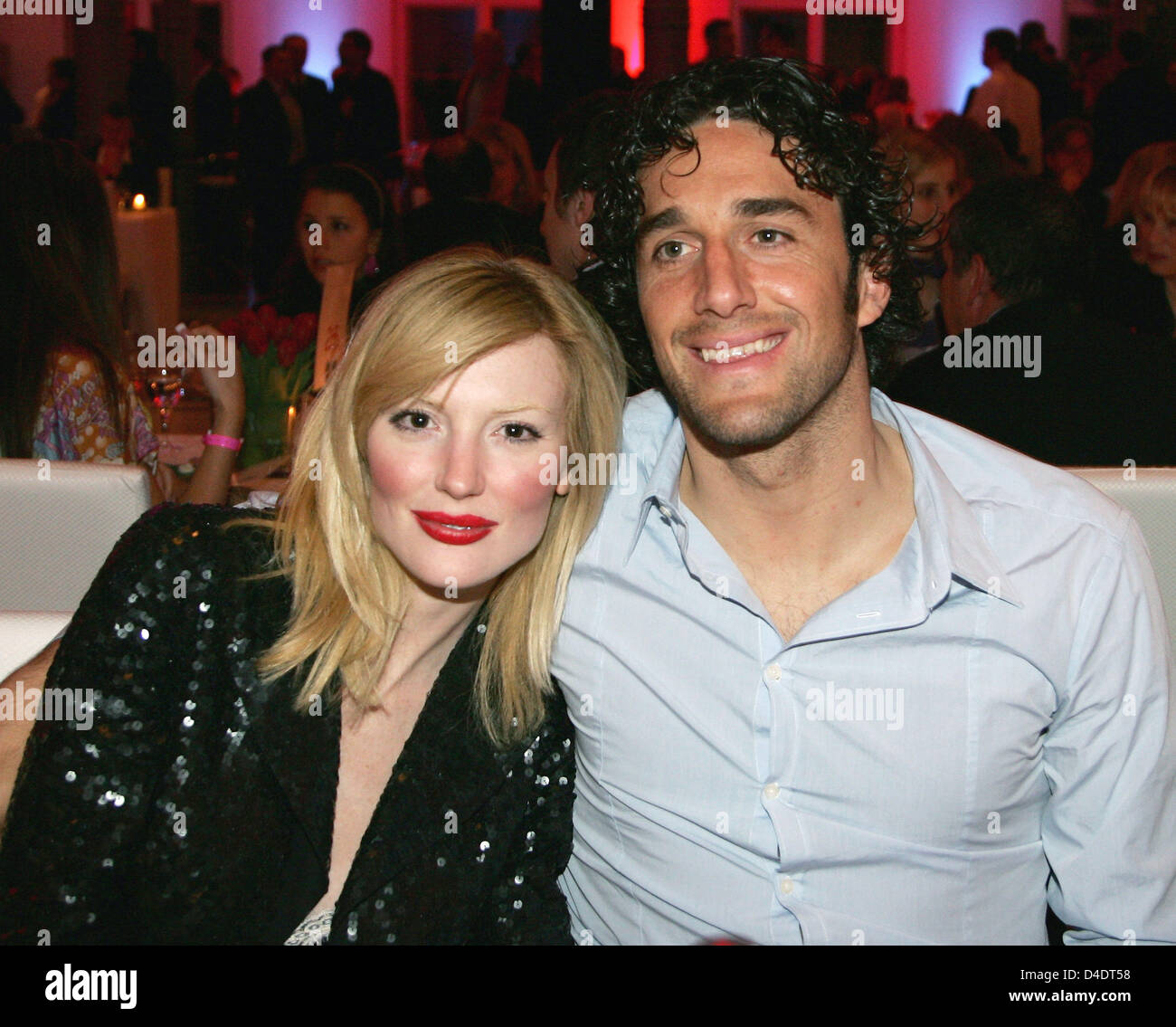 Luca Toni of Bayern Munic poses with his girlfriend Marta Cecchetto and the DFB-Trophy during the Bayern Munich champions party after the DFB Cup Final match between Borussia Dortmund and FC Bayern Munich at the Deutsche Telekom Represantive House Berlin, Germany, in the early morning of 20 April 2008. Photo: Alexander Hassenstein Stock Photo