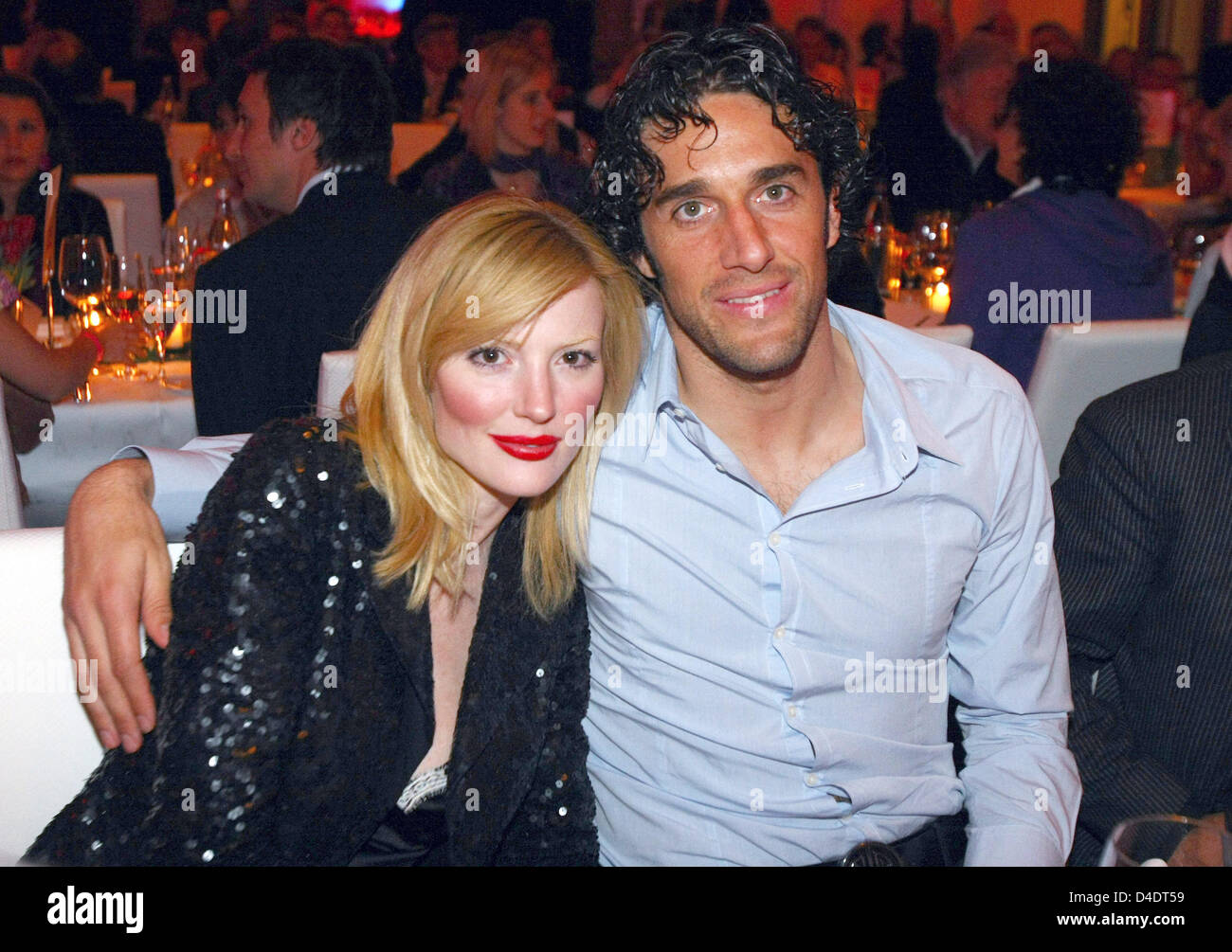 Luca Toni of Bayern Munic poses with his girlfriend Marta Cecchetto and the DFB-Trophy during the Bayern Munich champions party after the DFB Cup Final match between Borussia Dortmund and FC Bayern Munich at the Deutsche Telekom Represantive House Berlin, Germany, in the early morning of 20 April 2008. Photo: Alexander Hassenstein Stock Photo