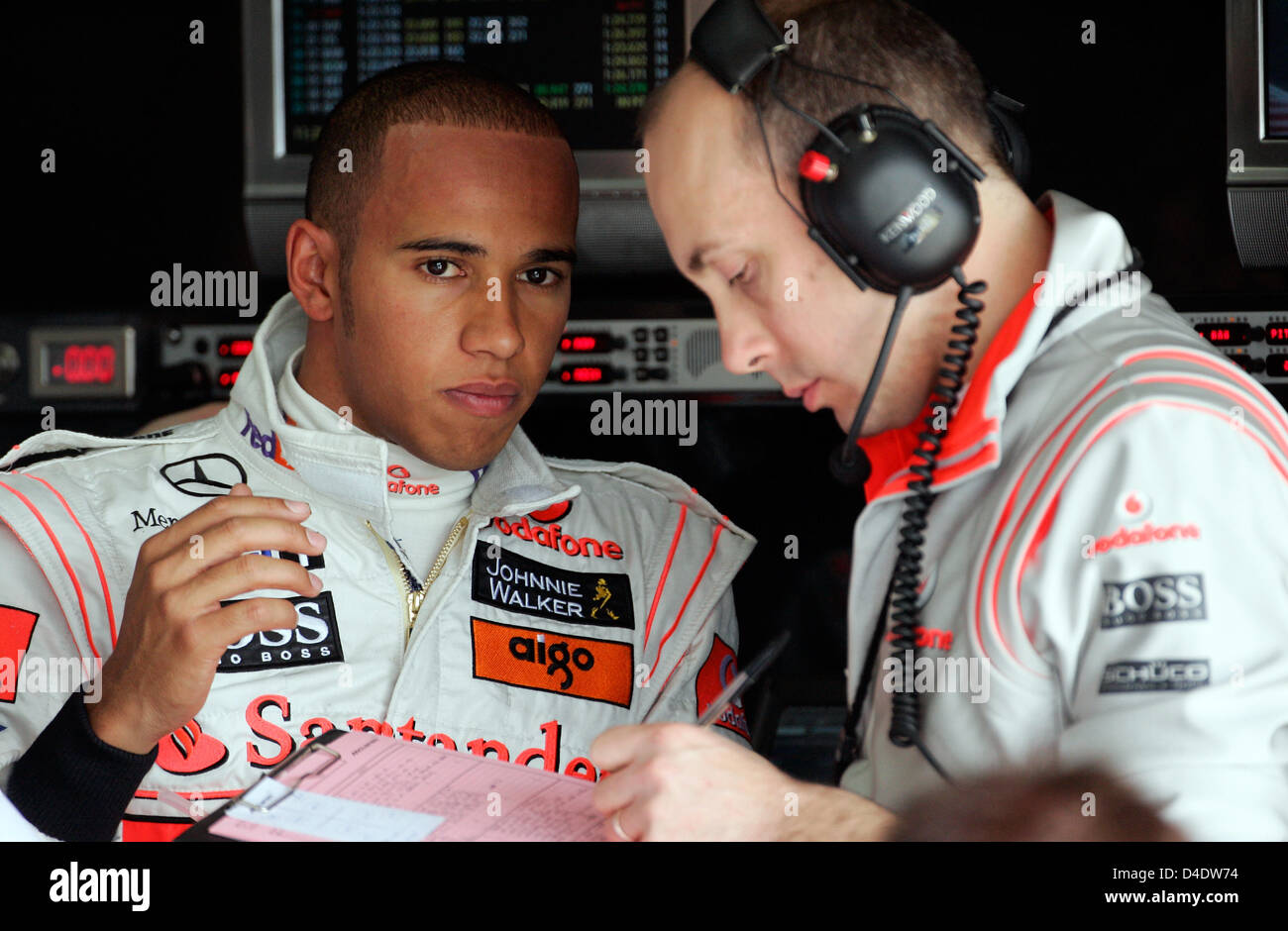 British Formula One driver Lewis Hamilton of McLaren Mercedes (L) confers with his race engineer Phil Prew (R) during the first practice session at Circuit de Catalunya in Montmelo near Barcelona, Spain, 24 April 2008. The Formula 1 Grand Prix of Spain be held here on 27 April. Photo: Felix Heyder Stock Photo