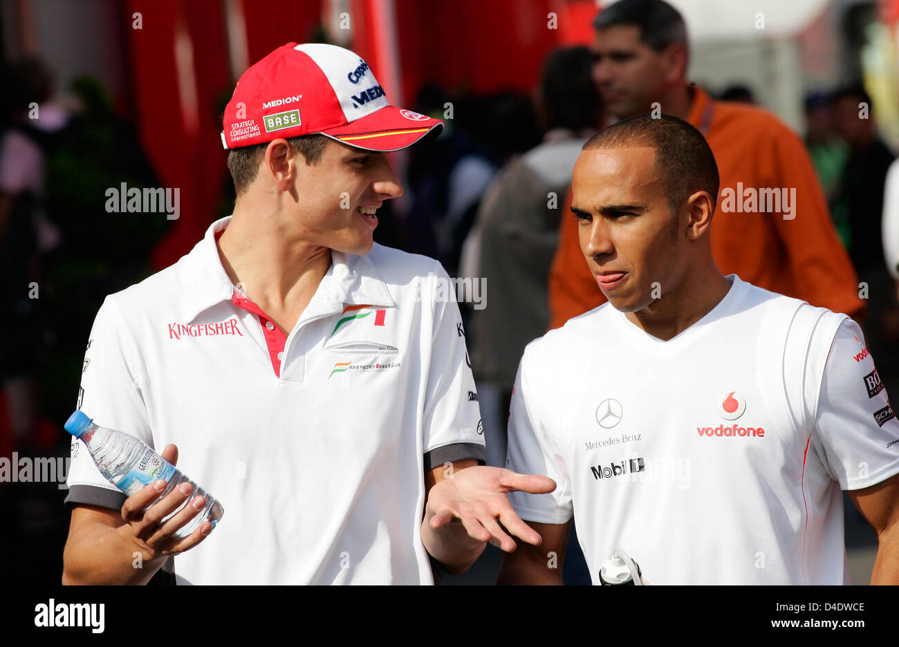 German Formula One driver Adrian Sutil of Force India (L) and British  Formula One driver Lewis Hamilton of McLaren Mercedes (R) walk through the  paddock of Circuit de Catalunya in Montmelo near