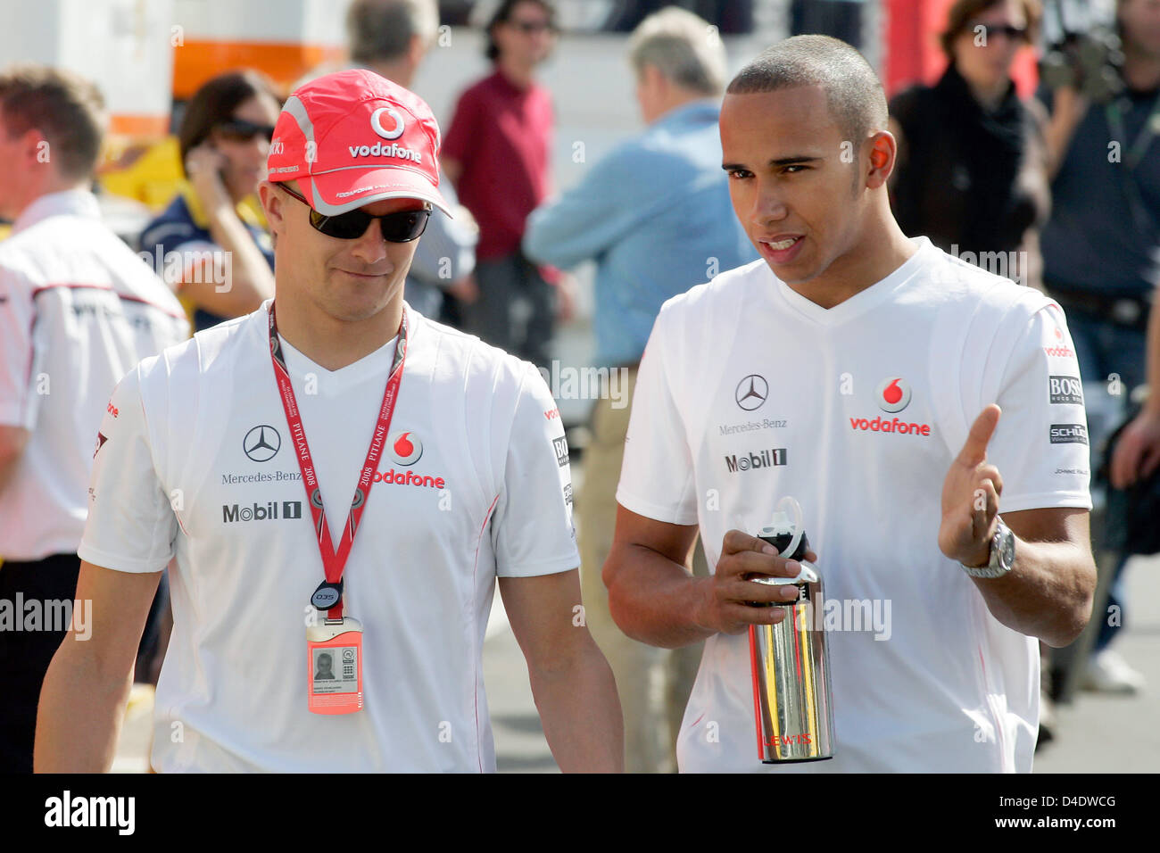 Finnish Formula One driver Heikki Kovalainen of McLaren Mercedes (L) and his British team-mate Lewis Hamilton (R) walk through the paddock of Circuit de Catalunya in Montmelo near Barcelona, Spain, 25 April 2008. The Formula 1 Grand Prix of Spain be held here on 27 April. Photo: Felix Heyder Stock Photo