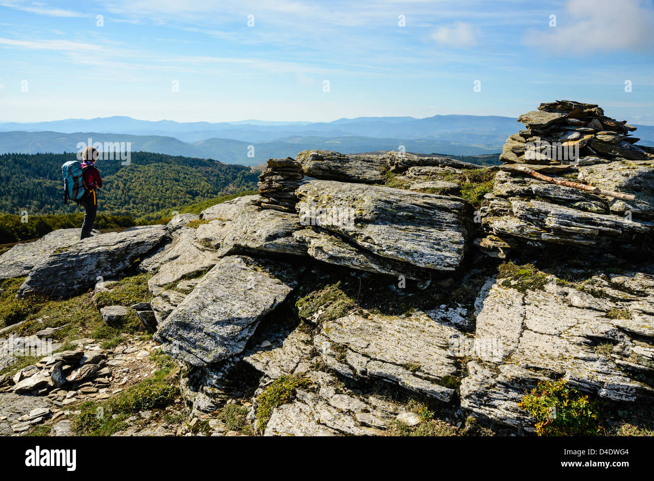 Walker at the summit of Signal de Bougès on the Robert Louis Stevenson Trail in the Cévennes, Lozère, France Stock Photo