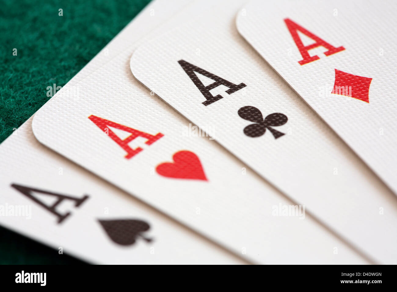 Close-up of four playing cards showing aces. Stock Photo
