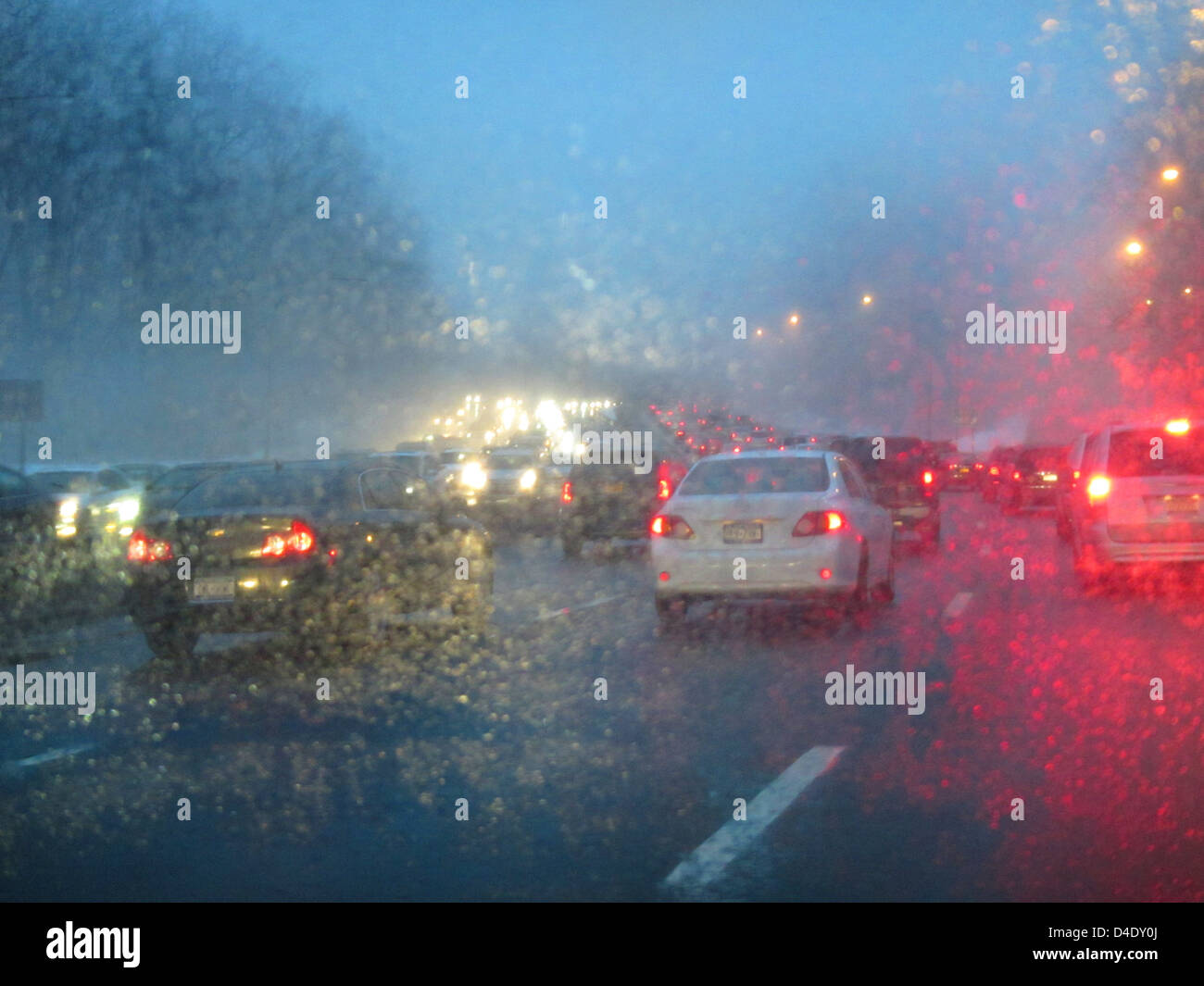 traffic on a rainy wet highway at dusk Stock Photo