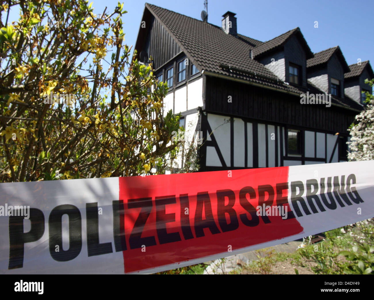 Barrier tape fences off a house in which three baby corpses were found in Wenden, Germany, 05 May 2008. A woman from Wenden is suspected to have killed and hidden three infants in the basement of a single-family house. The corpses were found in a freezer. Prior to this the police was informed by a member of the family. Photo: Federico Gambarini Stock Photo