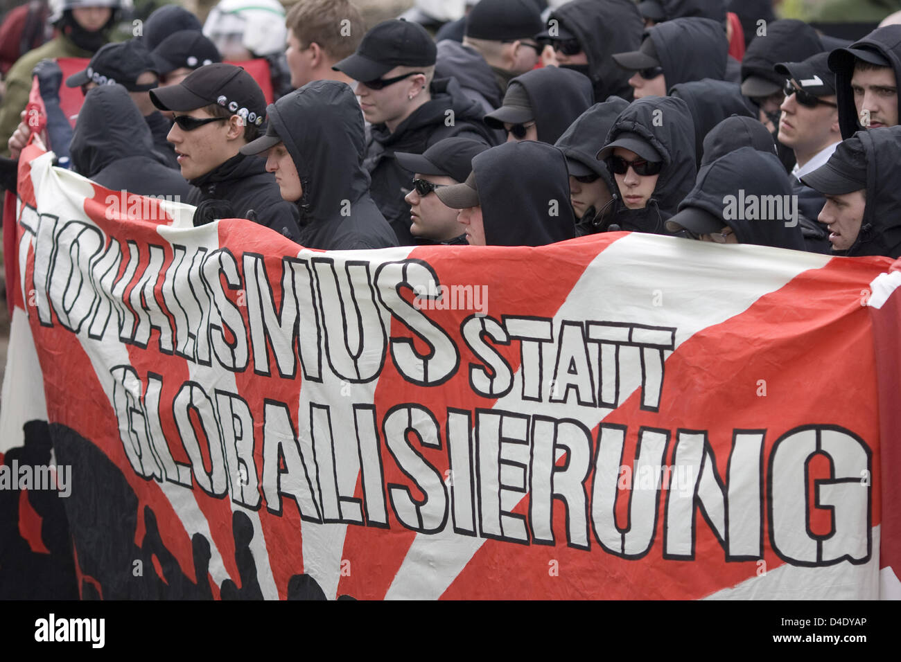 Hooded neo nazis and right wing extremists parade with a banner reading 'Nationalismus statt Globalisierung' ('Nationalism instead of Globalisation') during a Labour Day rally in Hamburg, Germany, 1 May 2008. Photo: Sebastian Widmann Stock Photo