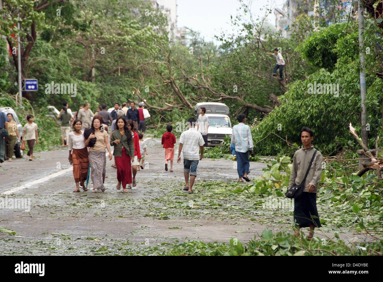 Toppled trees and other debris block a street in Yangon, Myanmar, 5 May 2008. International aid has begun after cyclone 'Nargis' devastated Myanmar, though the exact situation in the country, which is isolated from the outside world by the military junta, remains unclear. Most traffic routes are blocked, Myanmar's government assumes that more than 15,000 people were killed and hund Stock Photo