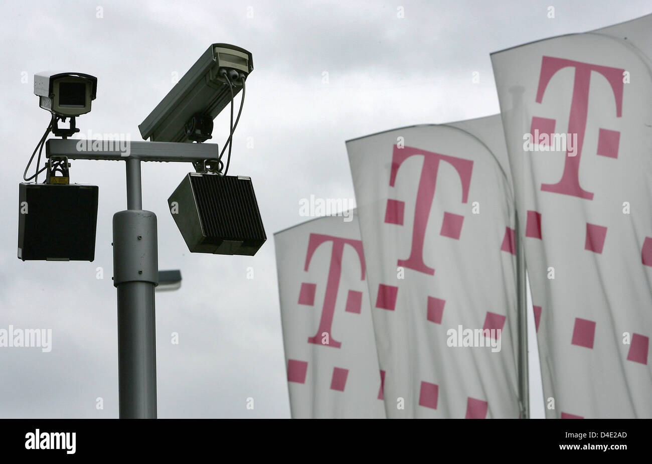 CCTV cameras seen next to the logo of Deutsche Telekom at the company headquarters in Bonn, Germany, 6 Ocotber 2008. Data protection continues to challenge the company, ever since the scandal of May 2008. Deutsche Telekom CEO Obermann, who had to admit that Telekom spied on journalists and members of the supervisory board, was not charged during the earlier scandal, when officials  Stock Photo