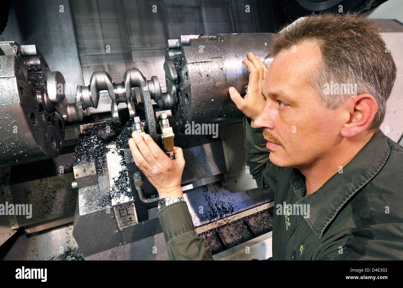 Plant manager Andreas Keitel of 'Fire Powertrain GmbH & Co KG' is pictured in a machining centre for crank shafts in Nordhausen, Germany, 07 October 2008. The company produces crank shafts for well-known automobile manufacturers such as Volkswagen, Audi, MAN and Daimler as well as the industrial engine manufacturer Cummins and JCB. The company exports almost 75 per cent of the prod Stock Photo