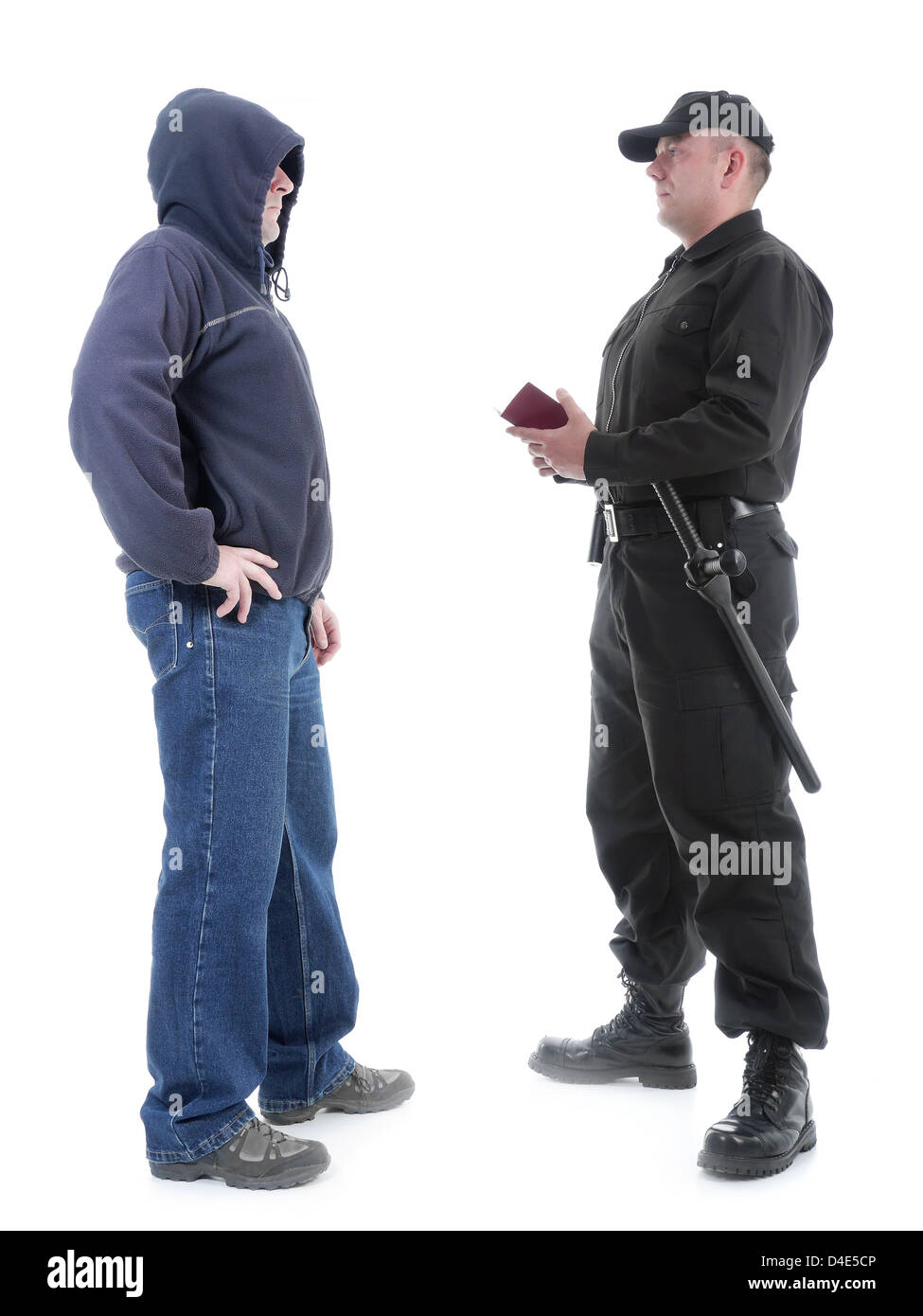 Policeman in black uniform checking ID of hooded suspect, shot on white Stock Photo