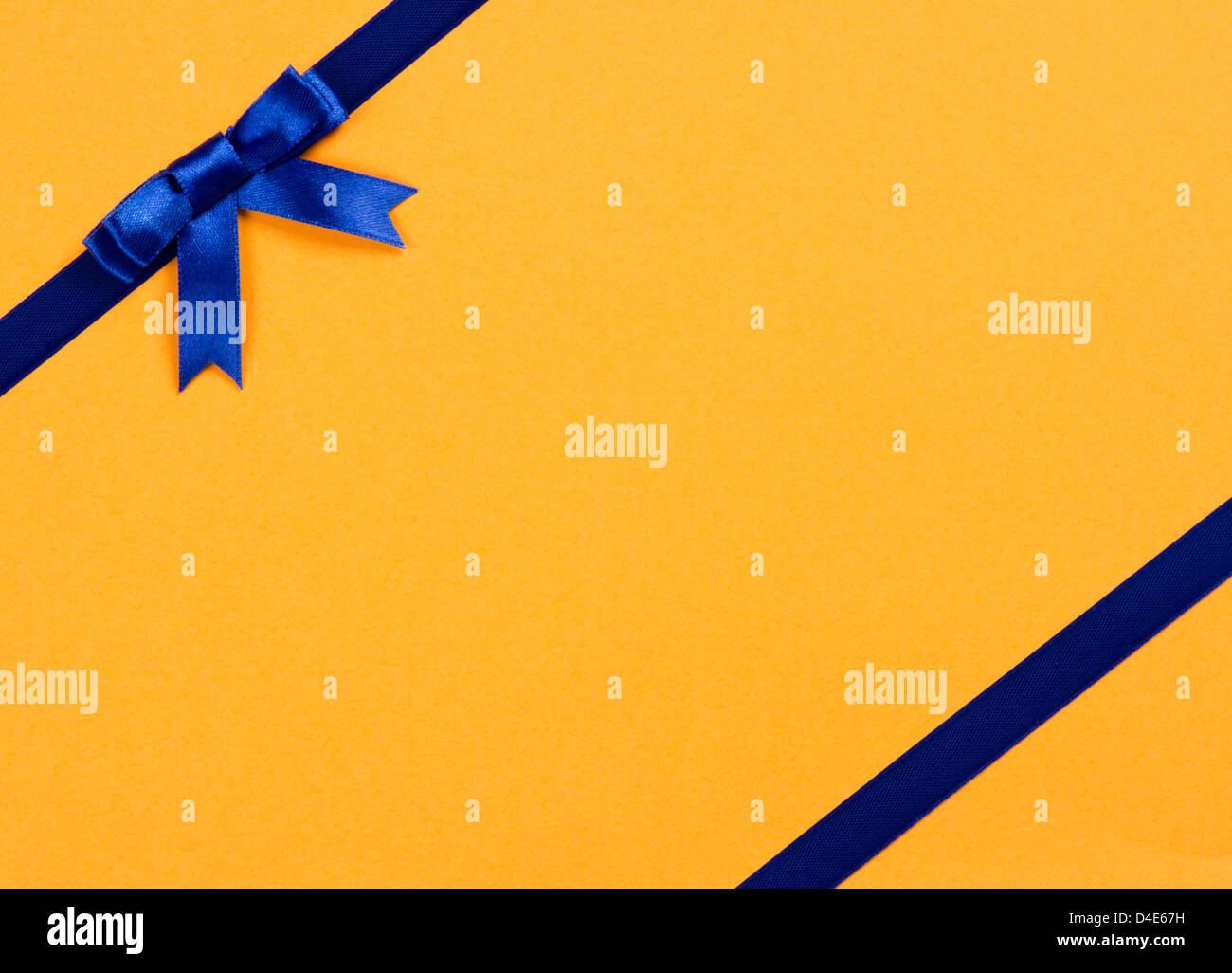 blue ribbon bow on yellow background Stock Photo - Alamy