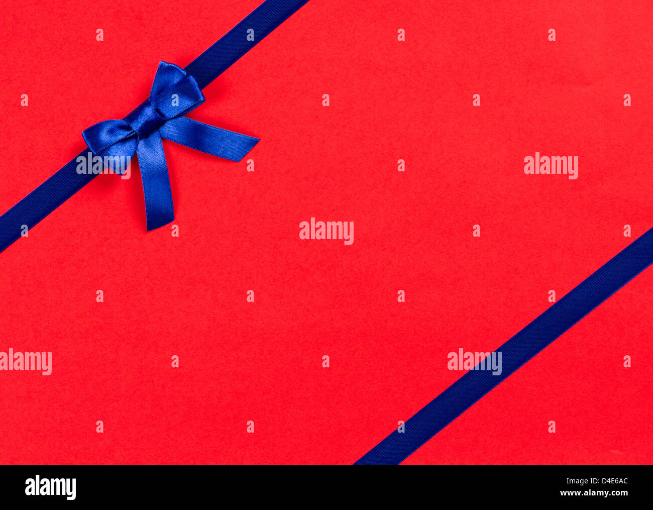 blue ribbon bow on red background Stock Photo - Alamy