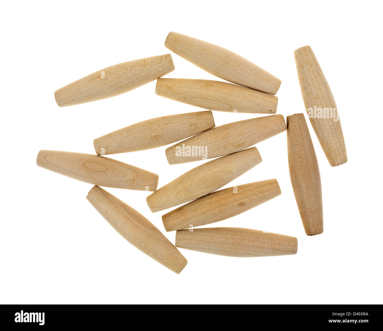 A group of tapered hardwood dowels on a white background. Stock Photo
