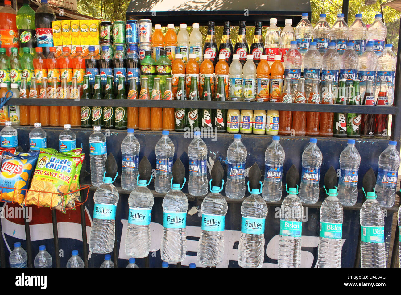 Small street shop which sells bottled or canned soft drinks or water and snacks Rajasthan India Stock Photo