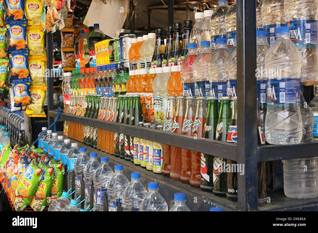 Small street shop which sells bottled or canned soft drinks or water and snacks Rajasthan India Stock Photo