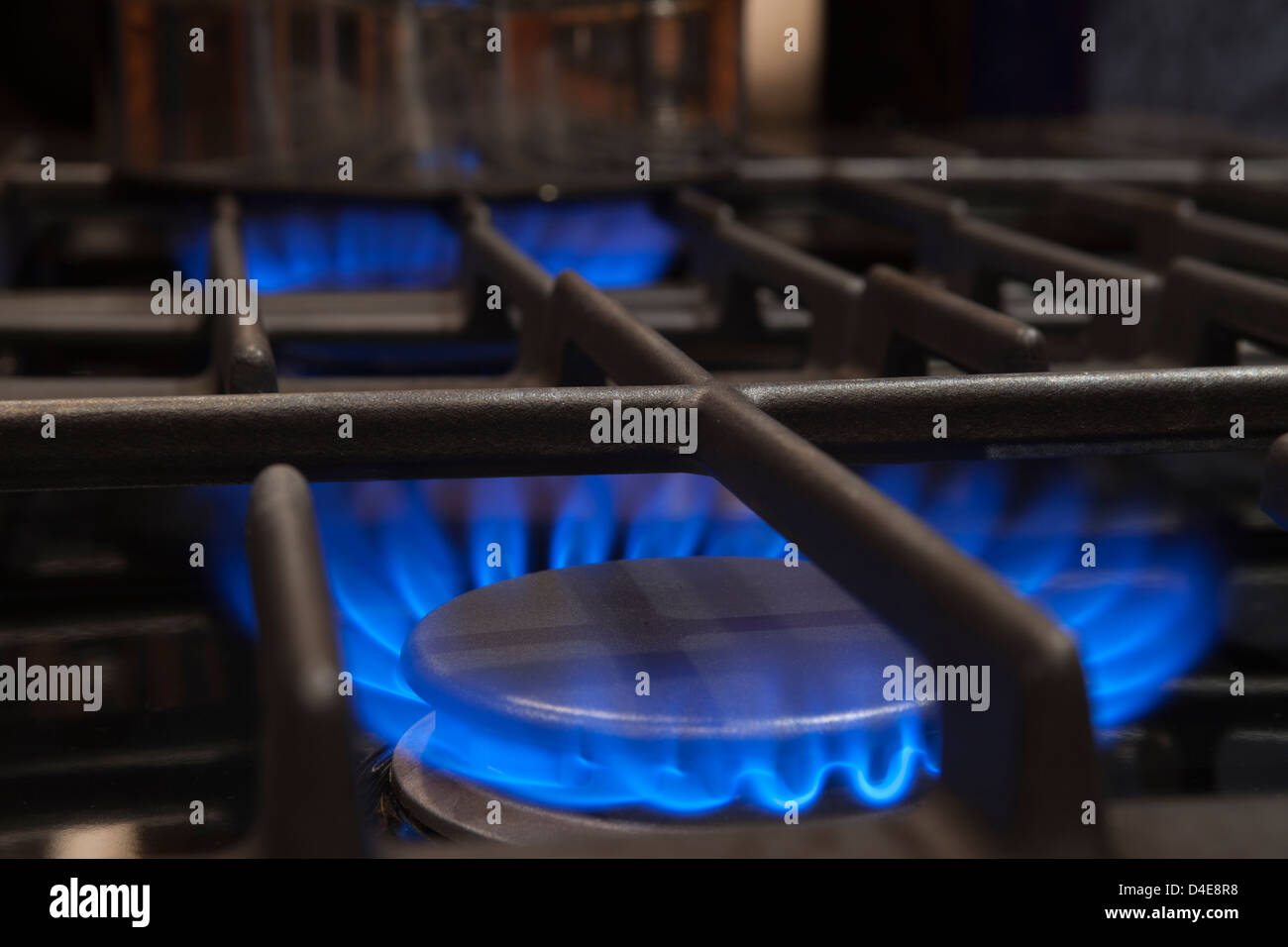 BLUE FLAME OF LIT GAS BURNER RINGS ON STOVE RANGE TOP Stock Photo Alamy