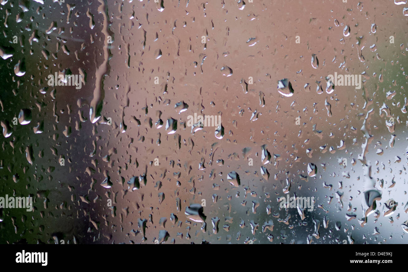 Raindrops running down a windowpane Stock Photo