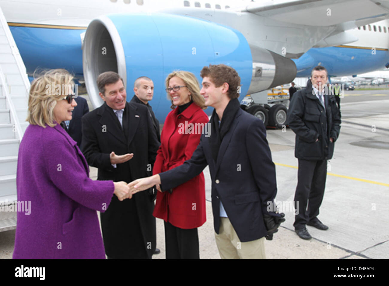 Secretary Clinton Is Welcomed to Paris By Ambassador Rivkin, Ms. Tolson, and His Son Stock Photo