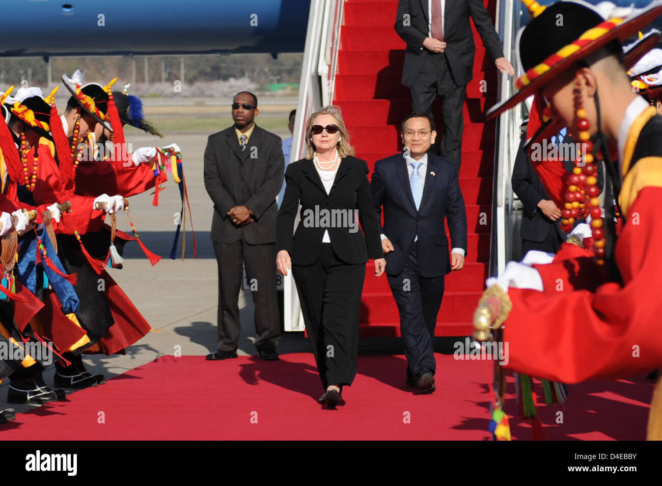 Secretary Clinton Is Escorted By Ministry of Foreign Affairs and Trade Deputy Director General Ahn Seung-doo Stock Photo