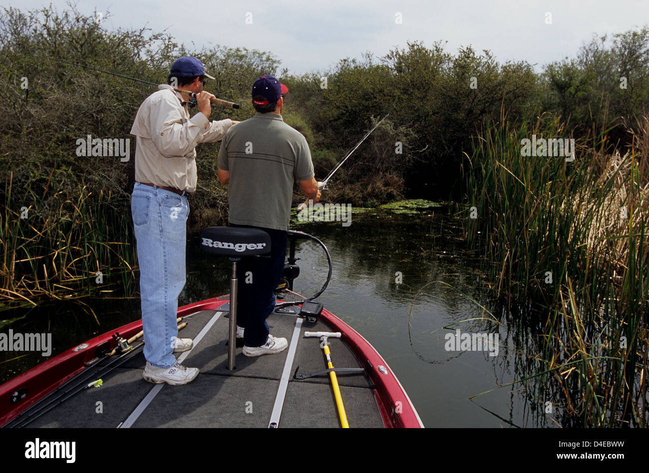 Two men fishing for bass from a boat on Choke Canyon Lake Texas Stock Photo