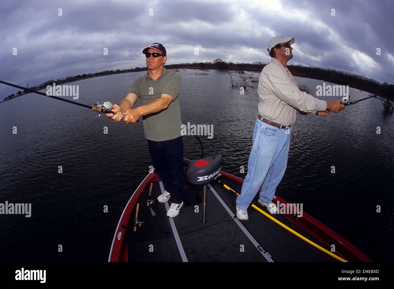Two men fishing for bass from a boat on Choke Canyon Lake Texas Stock Photo