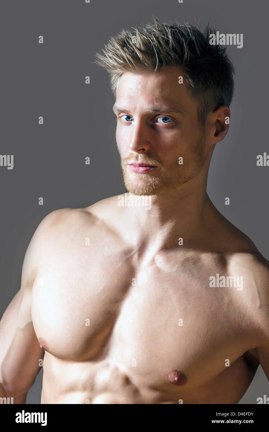 Portrait of a muscle sport man with blue eyes, blond hair and strong  pectoral muscles Stock Photo - Alamy
