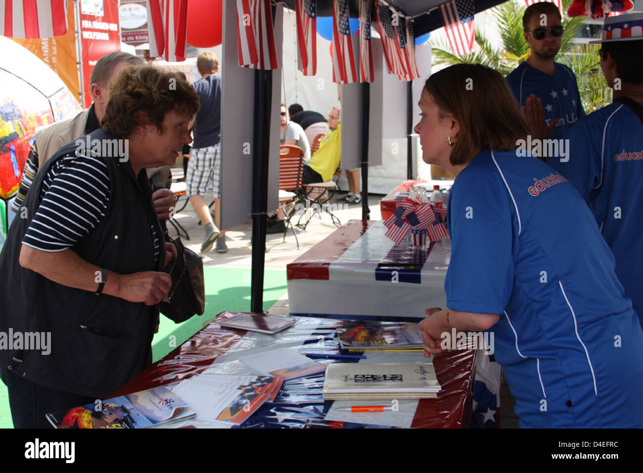 Cultural Affairs Assistant Gerda MierswaSilva speaks with guests at the Consulate Booth at the 'Fanmeile' Stock Photo