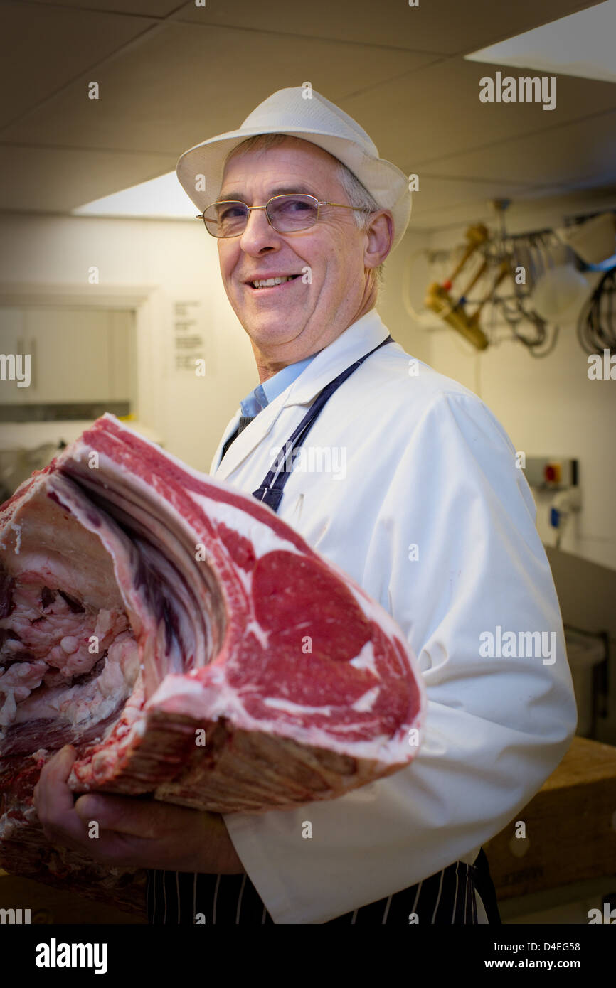 A traditional English butcher with a Rib of beef in a butchers shop