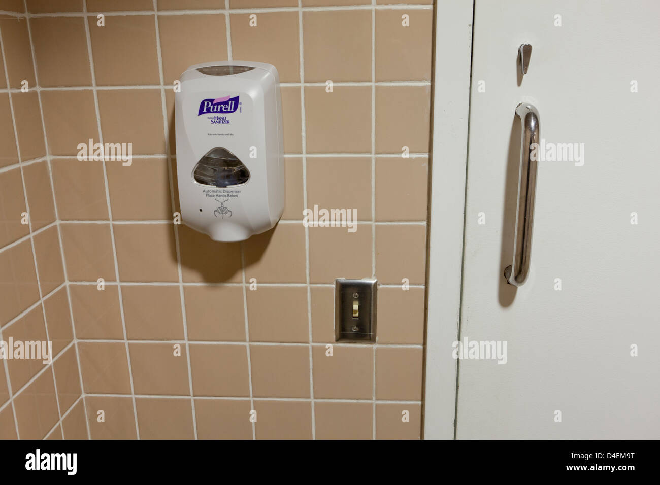 Hand sanitizer on public restroom wall - USA Stock Photo