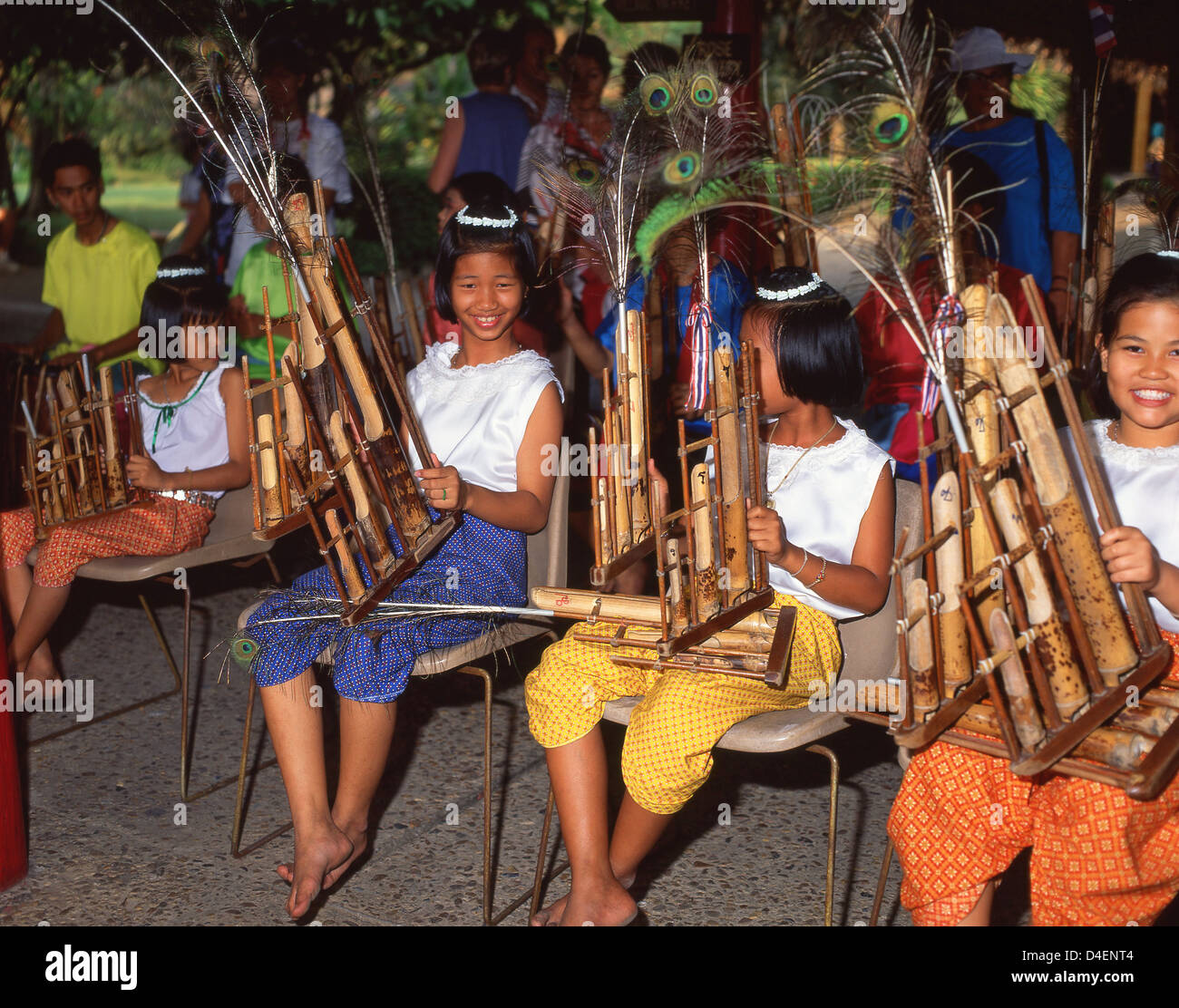 Children playing bamboo musical instruments at The Rose Garden, Sampran