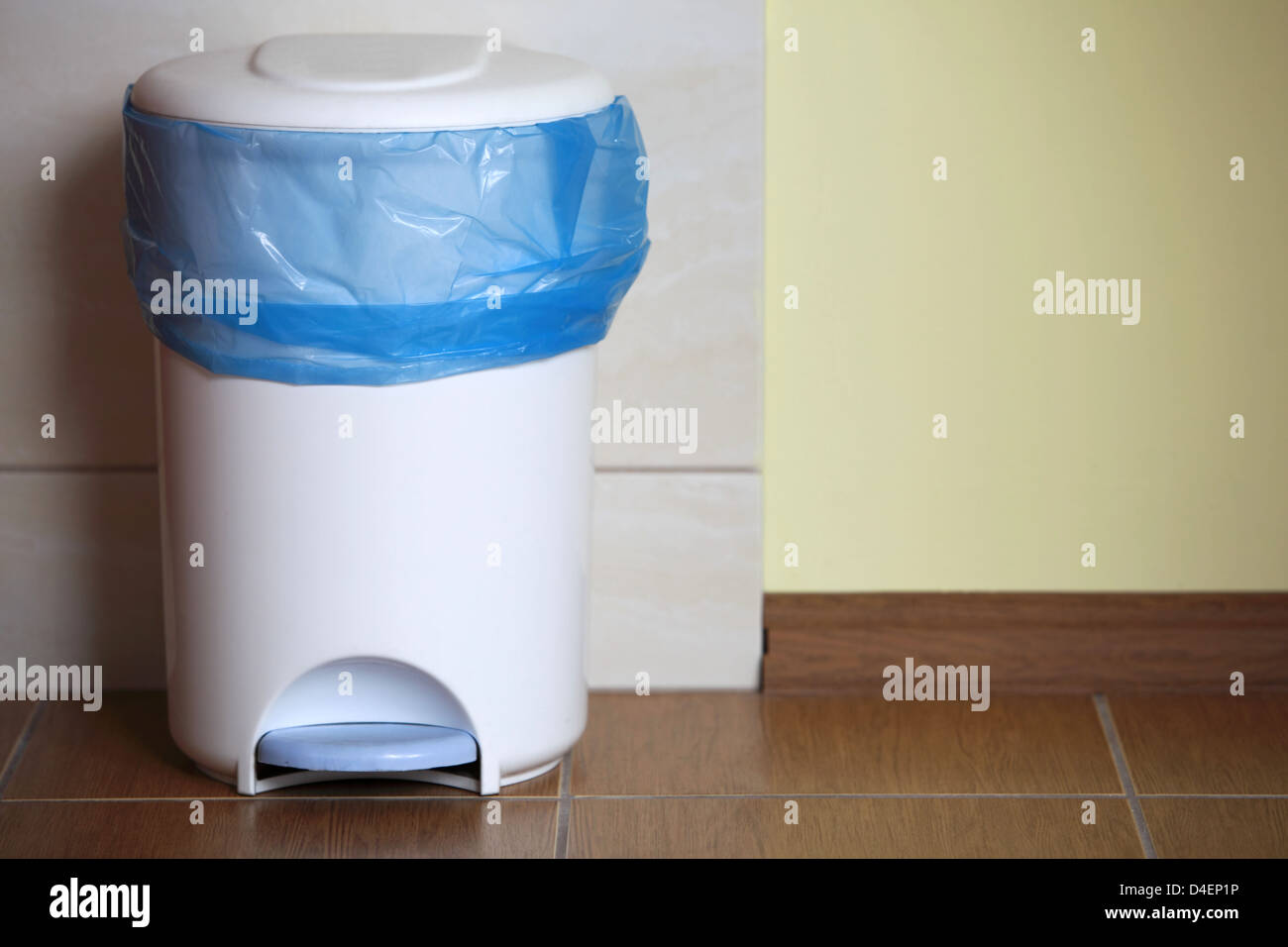 Trash can with a plastic bag inside indoor stock photo alamy