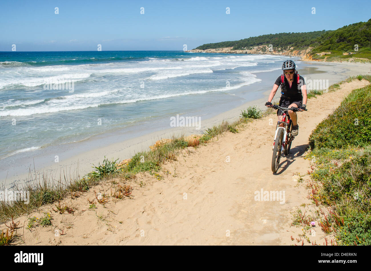 Mountain biker near Sant Tomas  on the Cami de Cavalls coastal path on Menorca in the Balearic islands, Spain Stock Photo